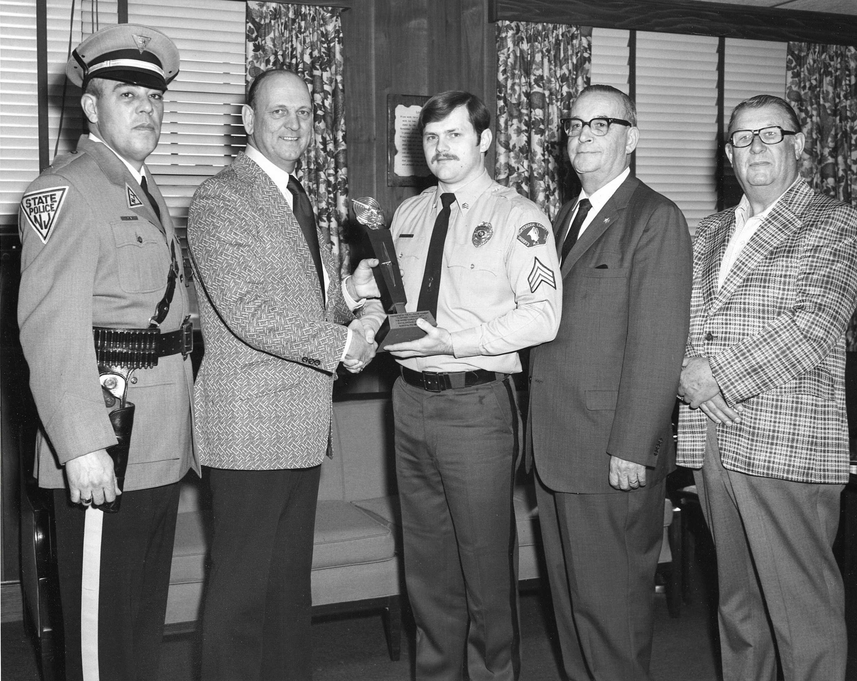 A Sergeant in the Hunterdon County Sheriff's Office receiving a pistol award from the Sea Girt Police Academy in 1975